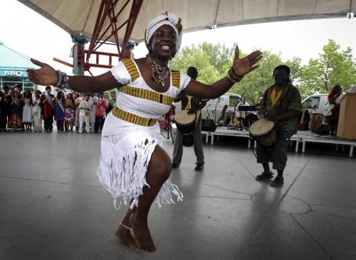 MIKE.DEAL@FREEPRESS.MB.CA 100722 - Thursday, July 22, 2010 -  Emelia Bonsu a dancer with the Ghanian Union of Manitoba Cultural Dance Group gets the crowed going at the start of the official launch of Folklorama at The Forks.  MIKE DEAL / WINNIPEG FREE PRESS