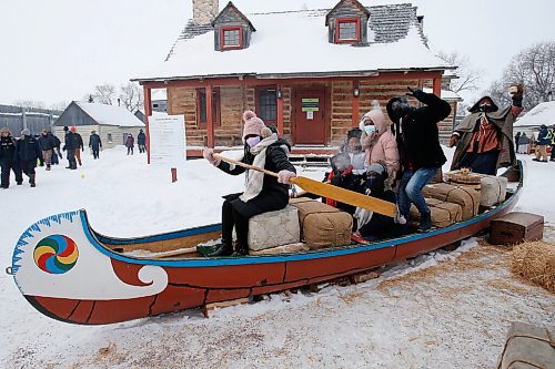 JOHN WOODS / WINNIPEG FREE PRESS
From left, Rebecca Augustin, David Ndaruhutse, Venita Uwase, Liliane Uwumutima, Aunice Augustin, and Kevin Ruganzu pose for a photo with a voyageur in a canoe in Fort Gibraltar at the Festival du Voyageur, Monday, February 21, 2022. weekend.

Re: standup