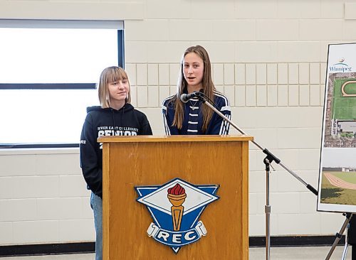 JESSICA LEE / WINNIPEG FREE PRESS

River East Collegiate students Natalie Wiebe, grade 11, and Madeline Penner, grade 12 (left) speak to students, staff and city staff at the announcement to build a new $850,000 track behind their school on February 22, 2022.

