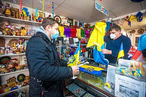 MIKAELA MACKENZIE / WINNIPEG FREE PRESS

Svitoch Ukrainian Export & Import owner Ruslan Zeleniuk (right) packs up flags for Alexey, who has family in the Luhansk region, in Winnipeg on Thursday, Feb. 24, 2022. For Erik story.
Winnipeg Free Press 2022.