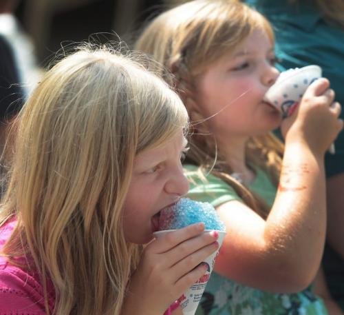JOE.BRYKSA@FREEPRESS.MB.CA Local(standup)- Fringe fans Emily, left, and Chelsea Fillion enjoy a ice cone at   Old Market Square Saturday afternoon- July 24, 2010 WINNIPEG FREE PRESS