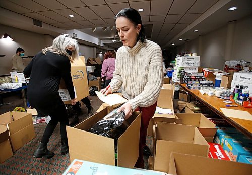 JOHN WOODS / WINNIPEG FREE PRESS
Anna Karpenko, right, and other volunteers pack boxes of requested essentials at the Ukrainian National Federation Tuesday, March 1, 2022. Karpenko organized the donation drive and plans to ship the items to Ukraine.

Re: Piche
