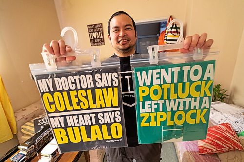 Daniel Crump / Winnipeg Free Press. Adonis Fernandez, 37, shows off some of the filipino themed shirts he designed and sells in his online store. March 2, 2022.