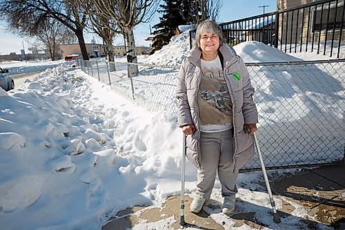MIKE DEAL / WINNIPEG FREE PRESS
Suzanne Jakeman who has cerebral palsy and uses elbow crutches stands outside her front gate where the sidewalk has not been cleared for quiet some time.
See Cody Sellar story
220303 - Thursday, March 03, 2022.