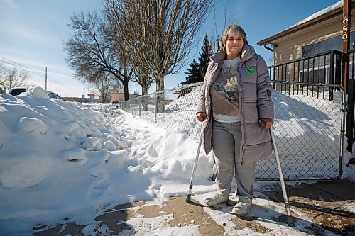 MIKE DEAL / WINNIPEG FREE PRESS
Suzanne Jakeman who has cerebral palsy and uses elbow crutches stands outside her front gate where the sidewalk has not been cleared for quiet some time.
See Cody Sellar story
220303 - Thursday, March 03, 2022.