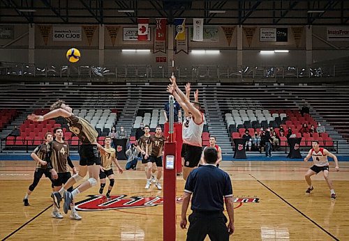 JESSICA LEE / WINNIPEG FREE PRESS

University of Manitoba Bisons player Spencer Grahme (left) spikes the ball during a finals game against The University of Winnipeg Wesmen on March 3, 2022.

Reporter: Taylor
