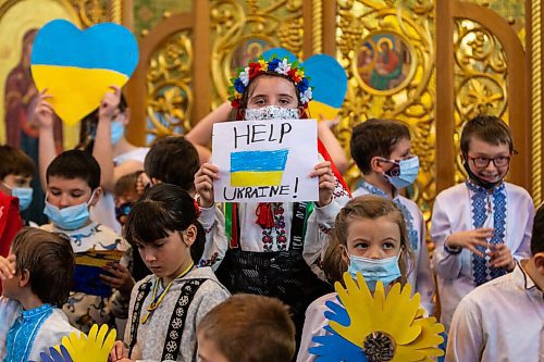 Daniel Crump / Winnipeg Free Press. A girl holds a sign as kids say prayers for Ukraine at the Ukrainian Catholic Metropolitan Cathedral of Sts. Volodymyr and Olha. March 5, 2022.