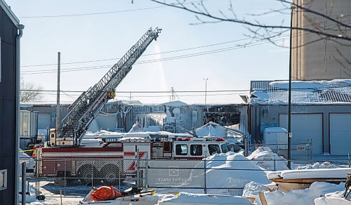 MIKE DEAL / WINNIPEG FREE PRESS
A single WFPS ladder truck continues to spray water onto a fire at a warehouse that started Sunday afternoon on Manahan Avenue.
A commercial warehouse is expected to be a complete loss after a fire Sunday.
Crews were expected to remain at the scene in the 1200 block of Manahan Avenue until late Sunday night.
Firefighters were sent there at about 4:39 p.m., and used aerial ladders to battle the blaze.
220307 - Monday, March 07, 2022.