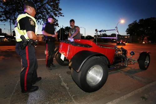 July 25, 2010 - 100725  - Winnipeg Police officers pull over Glen Ziolkowski and his 1923 T-Bullet for an inspection on north Main Street Sunday July 25, 2010.    John Woods / Winnipeg Free Press