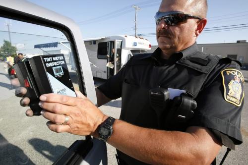 July 25, 2010 - 100725  - Patrol Sergeant Lou Malo inspects the window tint on a vehicle at a Winnipeg Police Service inspection station in Transcona Sunday July 25, 2010.    John Woods / Winnipeg Free Press