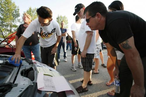 July 25, 2010 - 100725  - At a car rally in Transcona Justin Tropea details his Fairlady Z Twin Turbo as people check out the tickets he received earlier in the day for equipment violations on his car Sunday, July 25, 2010. John Woods / Winnipeg Free Press