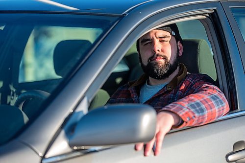 MIKAELA MACKENZIE / WINNIPEG FREE PRESS

Brett Parkin, who hasnt driven for SkipTheDishes for three weeks because of gas prices, poses for a portrait with his car in Winnipeg on Wednesday, March 9, 2022. For Gabby story.
Winnipeg Free Press 2022.