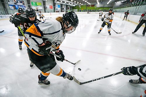 Daniel Crump / Winnipeg Free Press. A J. H Bruns player battle for the puck in the corner against several CSLR players. J.H. Burns plays CSLR in a womens high school hockey semi-final. At Southdale Community Centre in Winnipeg. March 9, 2022.