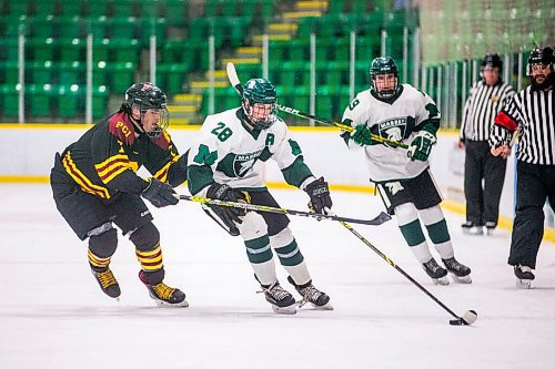 MIKAELA MACKENZIE / WINNIPEG FREE PRESS

Vincent Massey Trojan Matthew Lizotte (28) and Portage Trojan Noah Taylor (7) race for the puck during a Manitoba AAAA high school boys hockey championship game in Selkirk on Friday, March 11, 2022. Standup.
Winnipeg Free Press 2022.