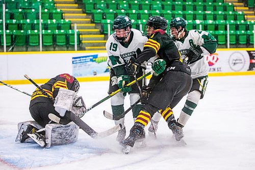 MIKAELA MACKENZIE / WINNIPEG FREE PRESS

Portage Trojan goalie Rowan Cherkas protects the puck as Vincent Massey Trojan Kaase Raeburn (19), Portage Trojan Maddox Shindle (6), and Vincent Massey Trojan Matthew Lizotte (28) pile up in front of the net during a Manitoba AAAA high school boys hockey championship game in Selkirk on Friday, March 11, 2022. Standup.
Winnipeg Free Press 2022.