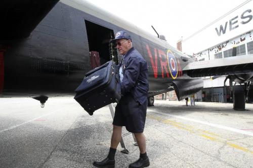 MIKE.DEAL@FREEPRESS.MB.CA 100729 - Thursday, July 29, 2010 -  The "Mynarski Memorial" Avro Lancaster Mk10 Bomber arrives at the Western Canada Aviation Museum and will be on display during the August long weekend. Charles Robertson (ground crew) unloads the flight crews luggage for the four day stopover. See Tania Kohut story MIKE DEAL / WINNIPEG FREE PRESS