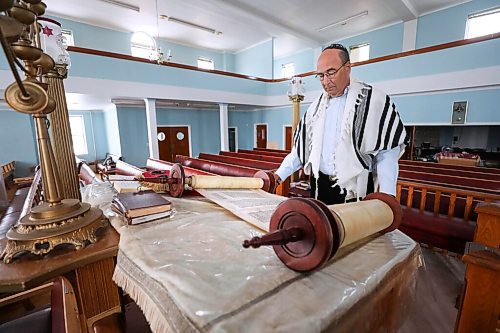 RUTH BONNEVILLE / WINNIPEG FREE PRESS

FAITH - synagogue / museum

Dr. Gerald Minuk, spreads open one of the scrolls from the Torah at the orthodox  Ashkenazie Synagogue located at 297 Burrows Ave. Monday.  

Dr. Gerald Minuk a volunteer chair of the Ashkenazies centennial committee, was involvement with turning the orthodox  Ashkenazie Synagogue located at 297 Burrows Ave  into a synagogue-museum.  

More info on this scroll.  The writing on this page of the Torah s God speaking to Moses to lead His people to freedom from the Pharaoh in Egypt. The Torah is hand-written in Hebrew with a quill on specially prepared parchment and sewn together with sinews to form one long scroll.


March 14th,  2022
