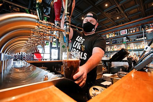 JOHN WOODS / WINNIPEG FREE PRESS
Jay Gilgour, owner of Fionn MacCools Restaurant and Pub, pulls a pint of Guinness at the pub Monday, March 14, 2022. With COVID-19 restrictions relaxing Kilgour and his staff are getting ready for the first St. Patricks Day celebration on March 17 to take place in two years.