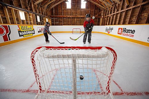 MIKE DEAL / WINNIPEG FREE PRESS
Matt (left) and Sam Rawlings (right) on the rink.
Dave Rawlings converted a barn on his property, with the help of his father Eric, into an indoor mini-skating rink. Including a heated change room. When the pandemic hit his kids, Sam and Matt, were able to skate almost everyday even during the worst lockdown stages.
See Ben Waldman story
220316 - Wednesday, March 16, 2022.