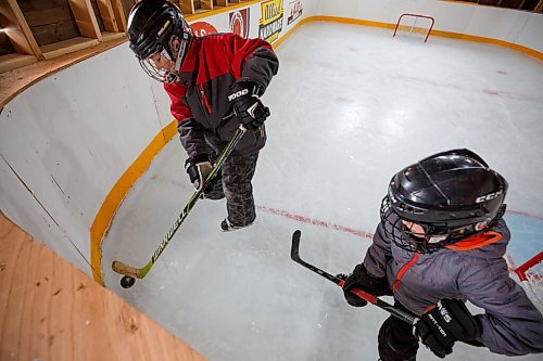 MIKE DEAL / WINNIPEG FREE PRESS
Matt (right) and Sam Rawlings (left) on the rink.
Dave Rawlings converted a barn on his property, with the help of his father Eric, into an indoor mini-skating rink. Including a heated change room. When the pandemic hit his kids, Sam and Matt, were able to skate almost everyday even during the worst lockdown stages.
See Ben Waldman story
220316 - Wednesday, March 16, 2022.