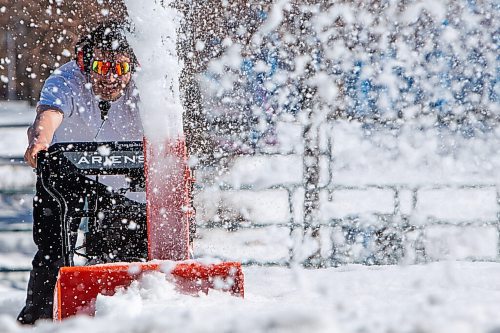 Daniel Crump / Winnipeg Free Press. Mitchell Ketler operates a snowblower as he and his friends help to clear snow from the skatepark at the Forks on Saturday afternoon. March 19, 2022.