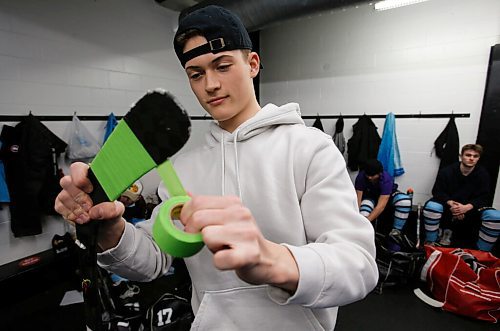 JOHN WOODS / WINNIPEG FREE PRESS
Easton Kapelus of the Lorette Scorpions, who is playing on  Winnipeg High School Hockey League (WHSHL) All-star team blue, tapes his stick in green in support of the Canadian Transplant Associations Green Shirt Day organ donor initiative in honour of the Logan Boulet Foundation at the Gateway arena in Winnipeg, Sunday, March 20, 2022.