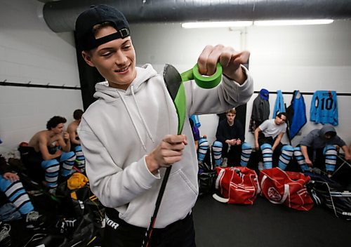 JOHN WOODS / WINNIPEG FREE PRESS
Easton Kapelus of the Lorette Scorpions, who is playing on  Winnipeg High School Hockey League (WHSHL) All-star team blue, tapes his stick in green in support of the Canadian Transplant Associations Green Shirt Day organ donor initiative in honour of the Logan Boulet Foundation at the Gateway arena in Winnipeg, Sunday, March 20, 2022.