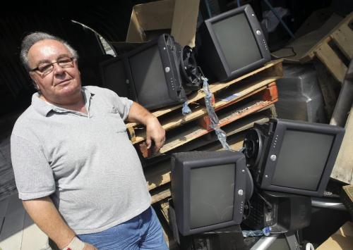 MIKE.DEAL@FREEPRESS.MB.CA 100804 - Wednesday, August 04, 2010 -  Tom Syrota, owner of Syrotech Industries, in his companies' yard piled high with electronic waste. MIKE DEAL / WINNIPEG FREE PRESS