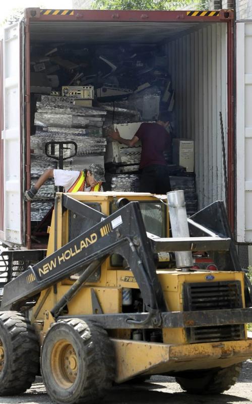 MIKE.DEAL@FREEPRESS.MB.CA 100804 - Wednesday, August 04, 2010 -  Workers at Syrotech Industries load up a shipping container with electronic waste. MIKE DEAL / WINNIPEG FREE PRESS