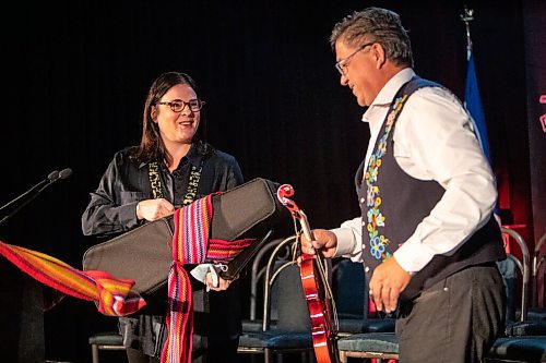 Daniel Crump / Winnipeg Free Press. Manitoba Premier Heather Stefanson is gifted a fiddle after speaking at the Manitoba Metis Federation annual general assembly at Assiniboine Downs on Saturday. March 26, 2022.