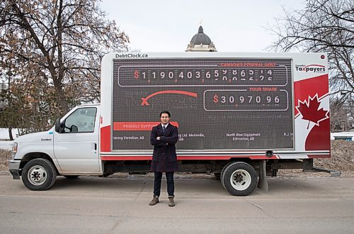 JESSICA LEE / WINNIPEG FREE PRESS

Franco Terrazzano, Federal Director of Canadian Taxpayers Federation, poses for a photo in front of the CTFs national debt clock, parked outside the Manitoba Legislative Building on March 28, 2022. The national debt clock shows the federal governments $1-trillion debt increasing in real time. 

