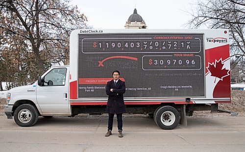 JESSICA LEE / WINNIPEG FREE PRESS

Franco Terrazzano, Federal Director of Canadian Taxpayers Federation, poses for a photo in front of the CTFs national debt clock, parked outside the Manitoba Legislative Building on March 28, 2022. The national debt clock shows the federal governments $1-trillion debt increasing in real time. 
