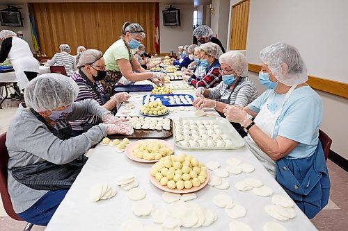 MIKE DEAL / WINNIPEG FREE PRESS
A busy table of pinchers steadily fill trays of perogies which will head to the kitchen to get boiled.
Holy Eucharist operates a year-round Perogy Hotline to raise funds for the church. Amid the crisis in Ukraine, the volunteers have started donating a portion of their proceeds to humanitarian efforts in the country.
see Eva Wasney story
220324 - Thursday, March 24, 2022.