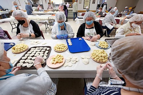 MIKE DEAL / WINNIPEG FREE PRESS
A busy table of pinchers steadily fill trays of perogies which will head to the kitchen to get boiled.
Holy Eucharist operates a year-round Perogy Hotline to raise funds for the church. Amid the crisis in Ukraine, the volunteers have started donating a portion of their proceeds to humanitarian efforts in the country.
see Eva Wasney story
220324 - Thursday, March 24, 2022.