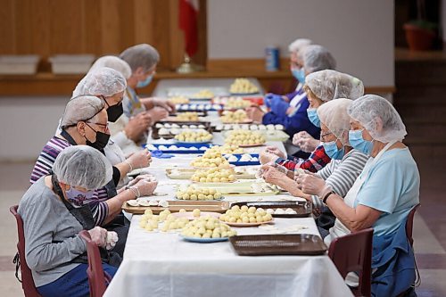 MIKE DEAL / WINNIPEG FREE PRESS
A busy table of pinchers steadily fill trays of perogies which will head to the kitchen to get boiled.
Holy Eucharist operates a year-round Perogy Hotline to raise funds for the church. Amid the crisis in Ukraine, the volunteers have started donating a portion of their proceeds to humanitarian efforts in the country.
see Eva Wasney story
220324 - Thursday, March 24, 2022.