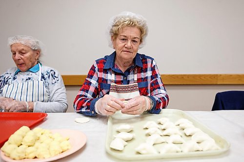 MIKE DEAL / WINNIPEG FREE PRESS
Teqyana Cwyk pinches perogies.
Holy Eucharist operates a year-round Perogy Hotline to raise funds for the church. Amid the crisis in Ukraine, the volunteers have started donating a portion of their proceeds to humanitarian efforts in the country.
see Eva Wasney story
220324 - Thursday, March 24, 2022.