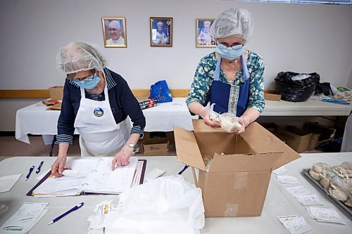 MIKE DEAL / WINNIPEG FREE PRESS
Lillian Deptuch (left) and Elaine Bowman (right) get an order ready for a waiting customer.
Holy Eucharist operates a year-round Perogy Hotline to raise funds for the church. Amid the crisis in Ukraine, the volunteers have started donating a portion of their proceeds to humanitarian efforts in the country.
see Eva Wasney story
220324 - Thursday, March 24, 2022.