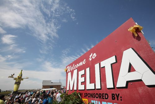 Brandon Sun 07082010 Residents and out-of-towners alike take in the unveiling ceremony for the Melita Banana on a scorching hot Saturday afternoon. (Tim Smith/Brandon Sun)