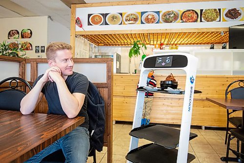 Mike Sudoma / Winnipeg Free Press
The newest hire at the Hong Du Khae restaurant, winks at patron Kyle Penner while delivering his food Wednesday afternoon
March 30, 2022