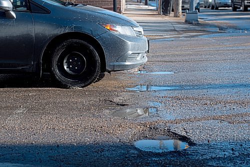 Mike Sudoma / Winnipeg Free Press
A car navigates a number of potholes at the intersection of Grovesnor Ave and Stafford St Wednesday evening
March 30, 2022