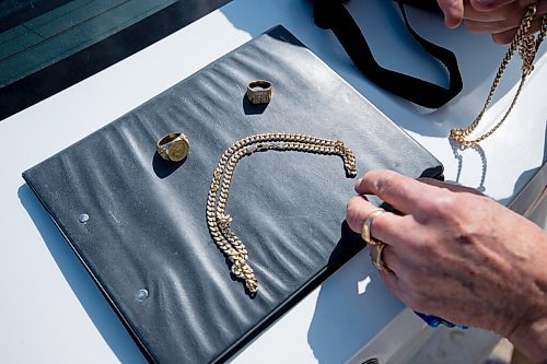 Mike Sudoma / Winnipeg Free Press
Retired school teacher, Gene Kirichenko, arranges the fake gold jewelry in the formation of a sad face after being conned out of $600 last week 
April 1, 2022