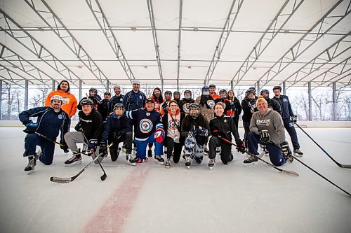 Daniel Crump / Winnipeg Free Press. Indigenous youth, professional hockey players and Winnipeg Jets training staff pose for a group photo after a skate at Camp Manitoou in Headingly. The skate is part of the Winnipeg Jets and Manitoba Moose WASAC programming. April 2, 2022.