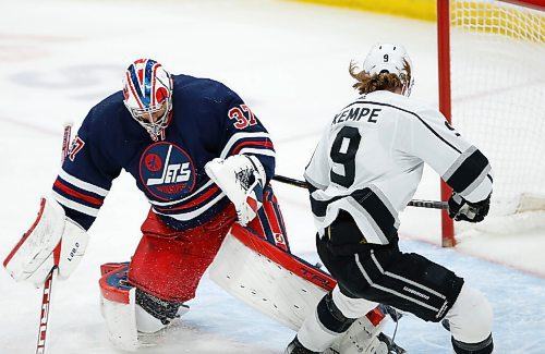 Los Angeles Kings' Adrian Kempe (9) scores on Winnipeg Jets goaltender Connor Hellebuyck (37) during first period NHL action in Winnipeg, Saturday, April 2, 2022. THE CANADIAN PRESS/John Woods