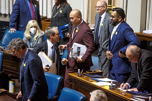 MIKE DEAL / WINNIPEG FREE PRESS
Obby Khan, MLA Fort Whyte, is greeted by members of the PC party as he arrives in the assembly chamber for his first Question Period, Monday afternoon.
220404 - Monday, April 04, 2022.