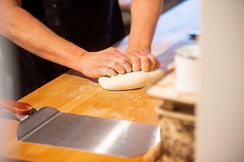 Mike Sudoma / Winnipeg Free Press
Bread maker, Jared Ozuks gets his hands dirty kneading a batch of dough in his kitchen Wednesday
April 5, 2022