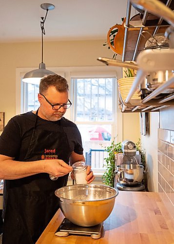 Mike Sudoma / Winnipeg Free Press
Jared Ozuk adds ingredients to his dough recipe in his kitchen Tuesday evening.
April 5, 2022