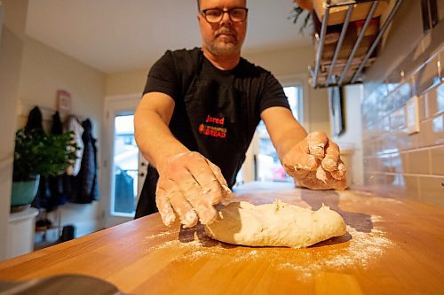 Mike Sudoma / Winnipeg Free Press
Bread maker, Jared Ozuks gets his hands dirty kneading a batch of dough in his kitchen Wednesday
April 5, 2022
