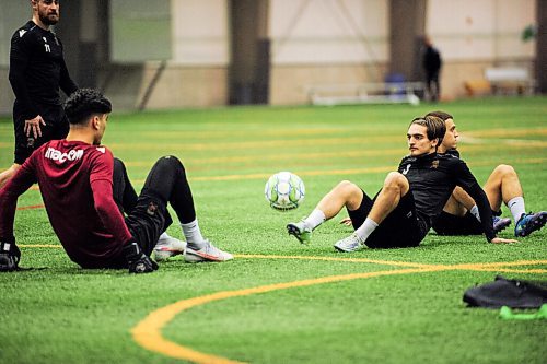 Mike Sudoma / Winnipeg Free Press
Valour FC Midfielder, Sean Rae, passes the ball to Goalkeeper, Rayanne Yesli, during a post practice cooldown drill Friday morning 
April 8, 2022