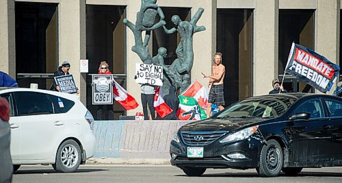 Mike Sudoma / Winnipeg Free Press
Freedom Protesters take dance and wave flags at the corner of Portage and Main Friday evening
April 8, 2022