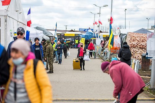 MIKAELA MACKENZIE / WINNIPEG FREE PRESS

Folks with suitcases and bags walk (likely gong back to the Ukraine) on the walkway to the border crossing at Medyka on Wednesday, April 6, 2022. For Melissa story.
Winnipeg Free Press 2022.